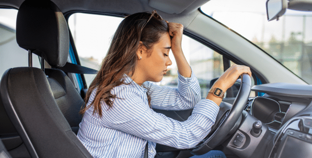 stressed out woman behind the wheel of a car