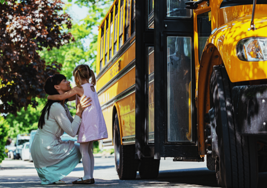 an image showing a mother and child preparing to get on a school bus
